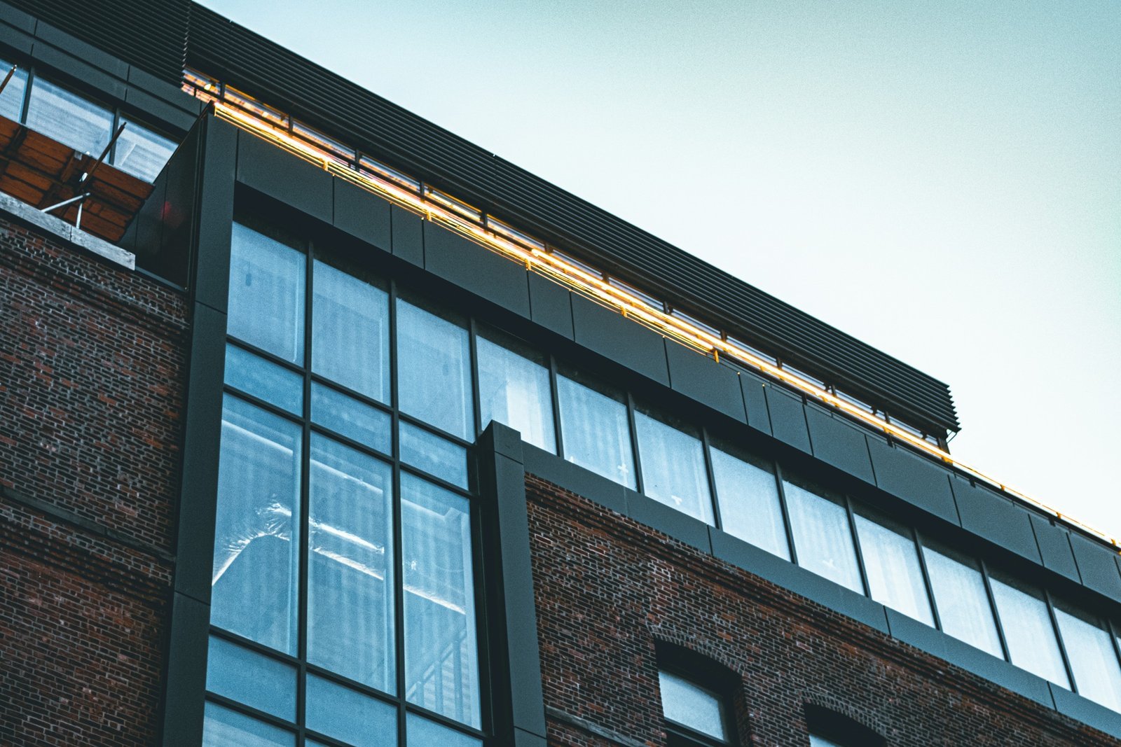 A brick building topped by a glass and steel addition