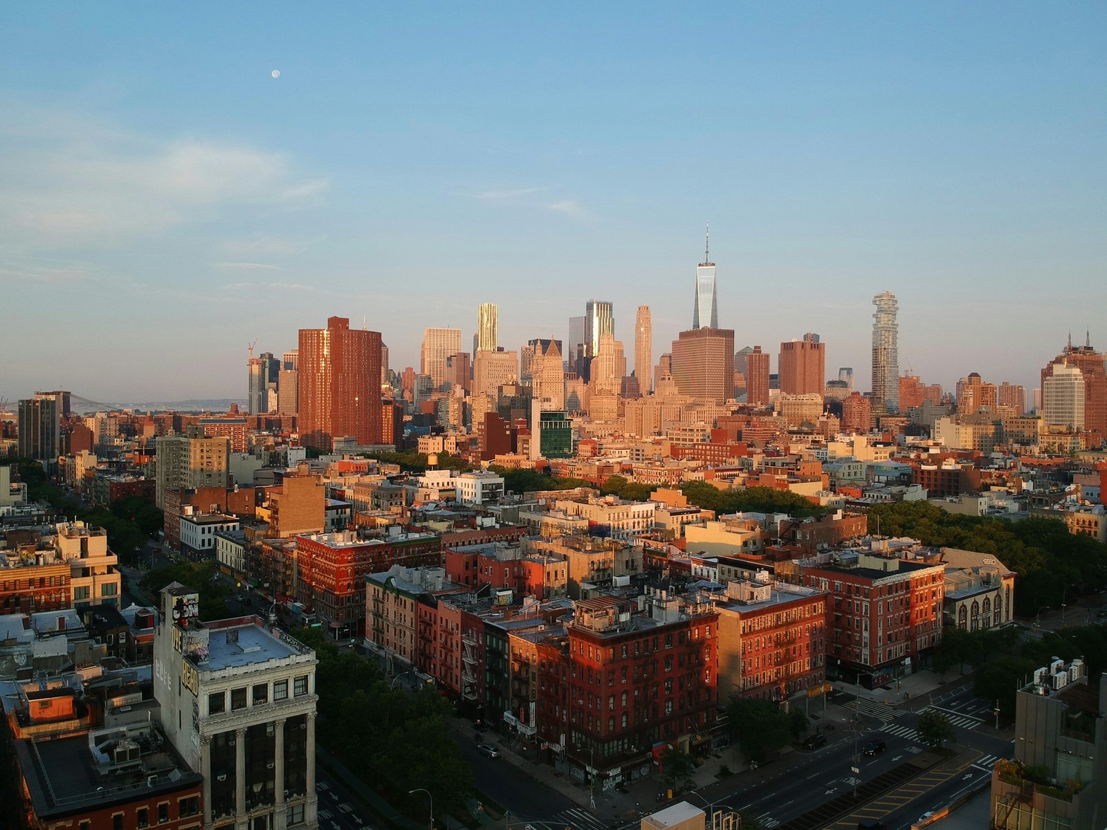 Low-rise blocks in early morning light with Midtown towers beyond