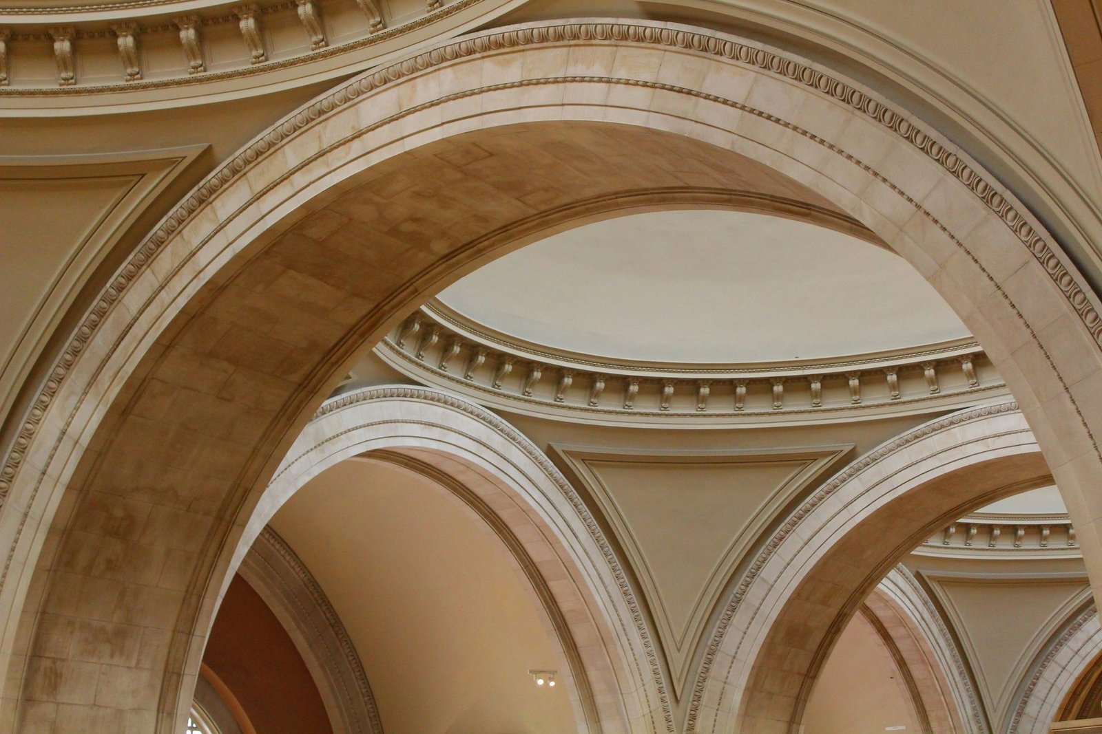 Stone arches and a domed ceiling in a museum hall