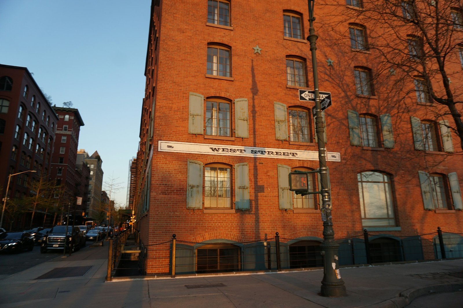 A red-brick loft building in low sun