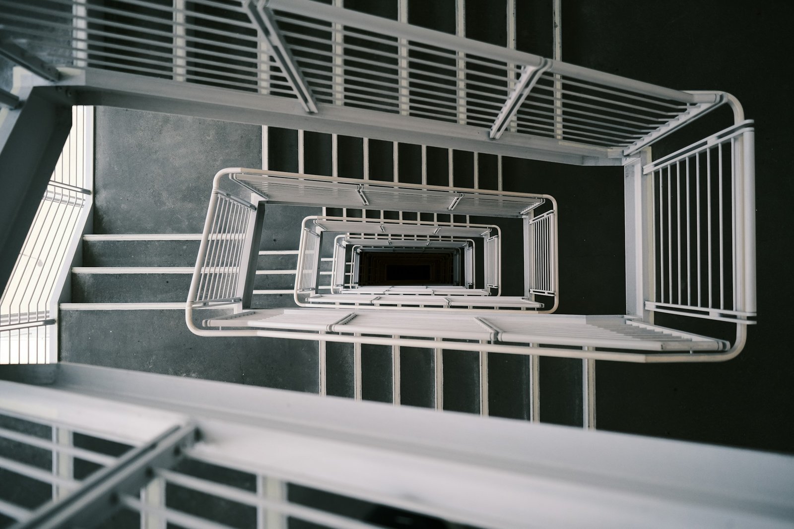 Looking down a square white stairwell